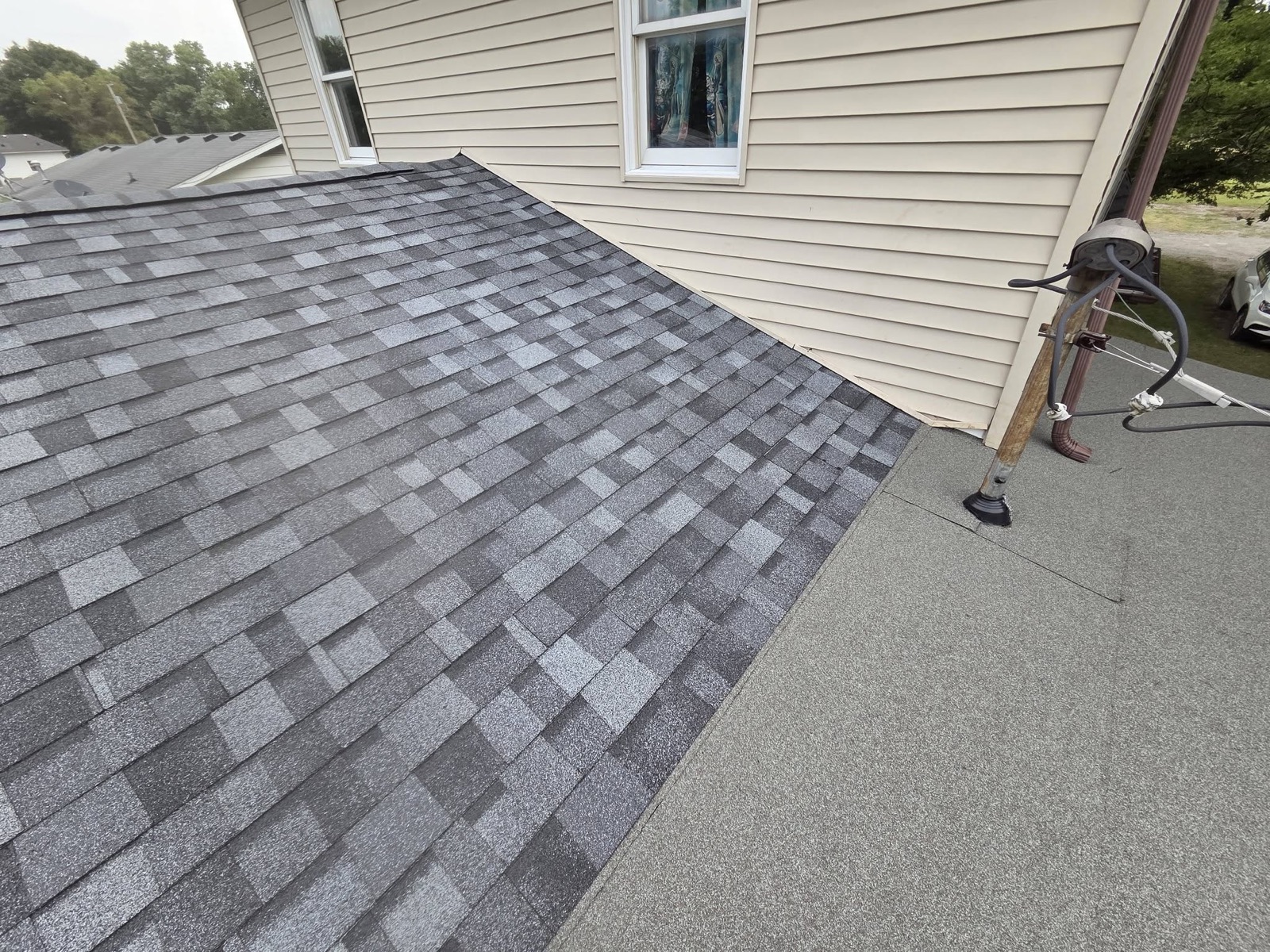 Close-up of roof-to-wall flashing and shingle detail work